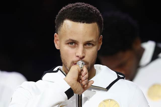 Step Curry of the Golden State Warriors kisses at his 2017-2018 Championship ring (Photo by Ezra Shaw/Getty Images)