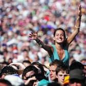 A festival-goer gets a good view over the crowd on the third and final day of the Glastonbury Music Festival 2005 (Photo: Matt Cardy/Getty Images)