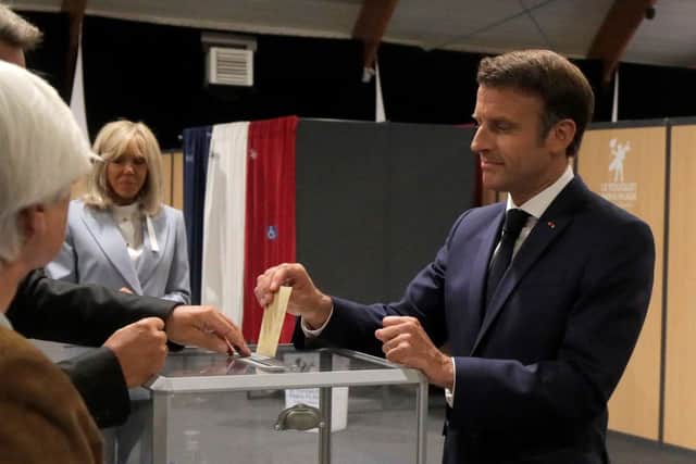 France’s President Emmanuel Macron casts his ballot next to his wife Brigitte Macron during the second stage of French parliamentary elections at a polling station in Le Touquet, northern France (Photo: MICHEL SPINGLER/POOL/AFP via Getty Images)