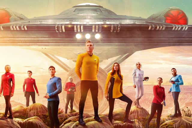 A retro poster for Star Trek: Strange New Worlds, depicting various cast members in front of the Enterprise (Credit: Paramount+) 