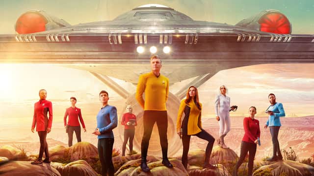 A retro poster for Star Trek: Strange New Worlds, depicting various cast members in front of the Enterprise (Credit: Paramount+) 