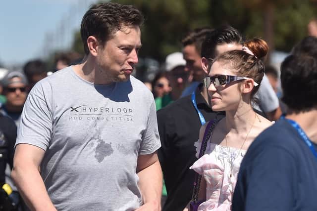 Elon Musk and Canadian musician Grimes attend the 2018 Space X Hyperloop Pod Competition, in Hawthorne, California on July 22, 2018 (Photo by ROBYN BECK/AFP via Getty Images)