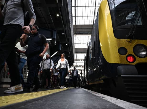 <p>Passengers disembark a train as the biggest rail strike in over 30 years hits the UK (Photo: BEN STANSALL/AFP via Getty Images)</p>