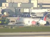 A plane has crashed in Miami and caught fire with 124 passengers on board (Pic: PTZ TV)