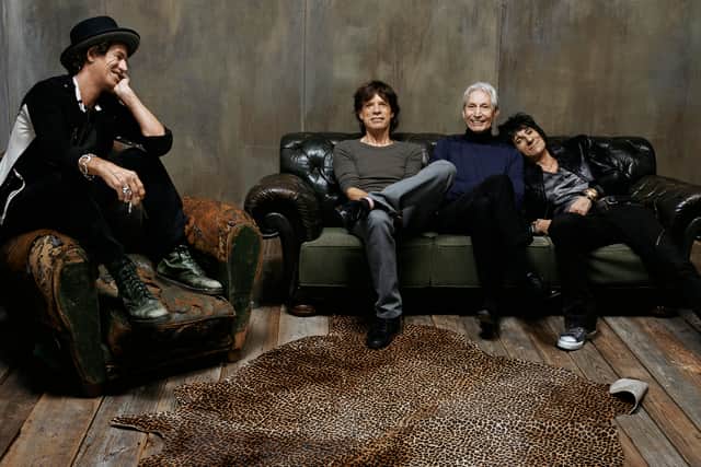 The Rolling Stones. Keith Richards is sat on an armchair, looking over fondly at his bandmates Mick Jagger, Charlie Watts, and Ronnie Wood, each sat on a sofa together (Credit: BBC/Mercury Studios/Steven Klein)