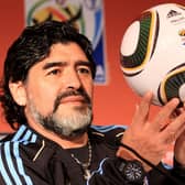 Diego Maradona holds up a match ball  during a press conference in Pretoria, South Africa (Pic: Getty Images)