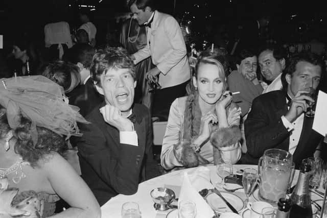 Mick Jagger and American model and actress Jerry Hall attend the Berkeley Square Ball, London, UK, 17th July 1984. (Photo by D. Jones/Daily Express/Hulton Archive/Getty Images)
