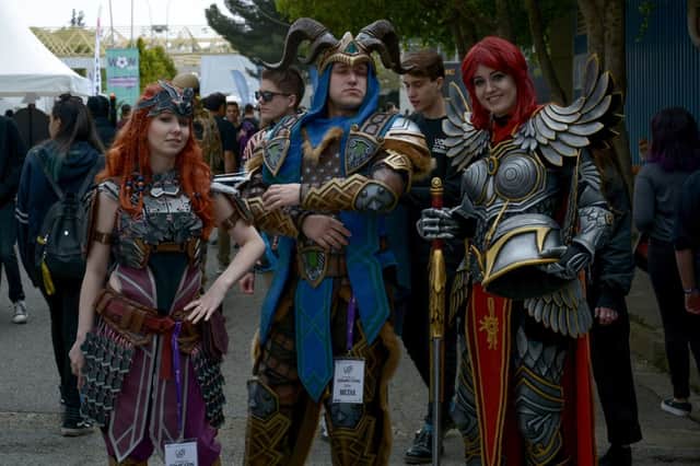 (L to R) Czech cosplayers Ketrin, portraying Aloy from the Horizon Zero Dawn video game, Ali, portraying the character Loki from the online game Smite, and Germia, portraying a paladin from the Might & Magic Heroes video game (Photo by ADEL AL SALMAN/AFP via Getty Images)