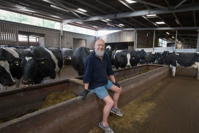  Festival founder Michael Eavis poses for a photograph as he checks on cows from his diary herd inside the cow shed at Worthy Farm (Pic: Getty Images)