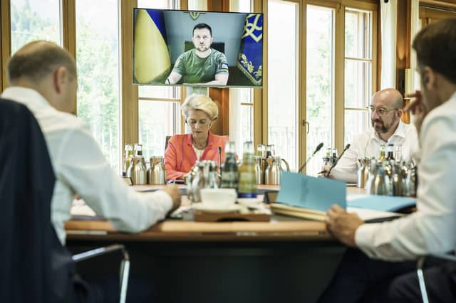(left to right) German Chancellor Olaf Scholz, European Union Commission President Ursula von der Leyen, European Union Council President Charles Michel, and President of France Emmanuel Macron listen to Ukrainian President Volodymyr Zelensky on a video link (PA)