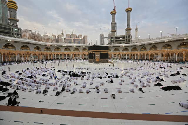 Worshippers perform the al-Adha prayers on the first day of the feast around the Kaaba, Islam's holiest shrine, at the Grand mosque in the holy Saudi city of Mecca, on July 20, 2021