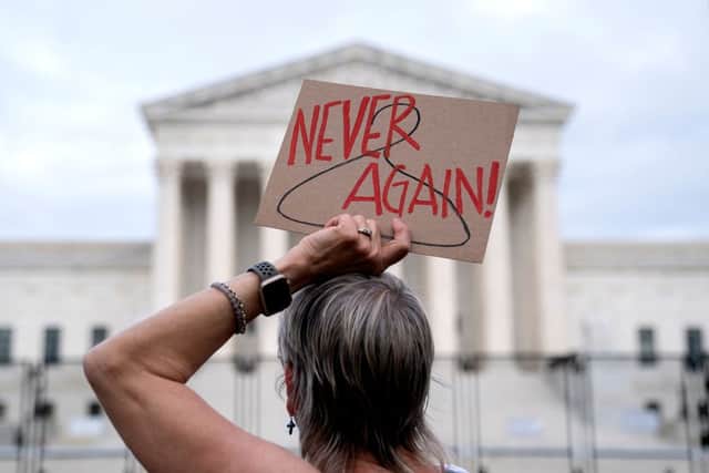 A pro-choice demonstrator holds a sign in front of the US Supreme Court in Washington, DC, on May 11, 2022 (Photo by STEFANI REYNOLDS/AFP via Getty Images)