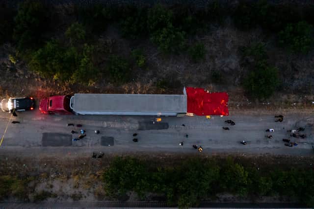 In this aerial view, members of law enforcement investigate a tractor trailer on June 27, 2022 in San Antonio, Texa