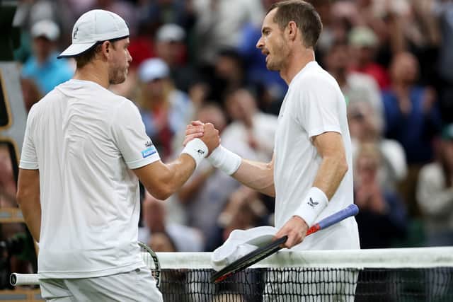 Andy Murray and James Murray shake hands over the net, after a spirited Centre Court encounter
