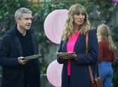 Martin Freeman as Paul and Daisy Haggard as Ava, stood in a garden holding cake at a child’s birthday party in an episode of Breeders (Credit: Sky/FX)
