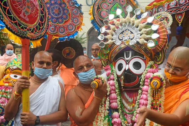 Temple priests and Hindu devotees carry an idol of Lord Jagannath as a symbolic gesture after the Rath Yatra procession was cancelled