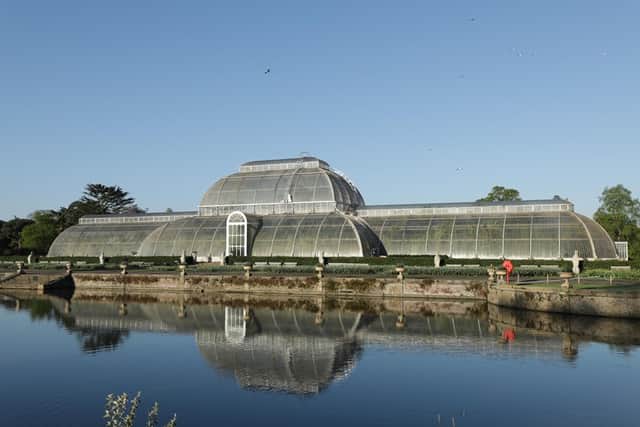 An image of Kew Gardens, a big glass conservatory behind a lake (Credit: Curve Media / Channel 5)
