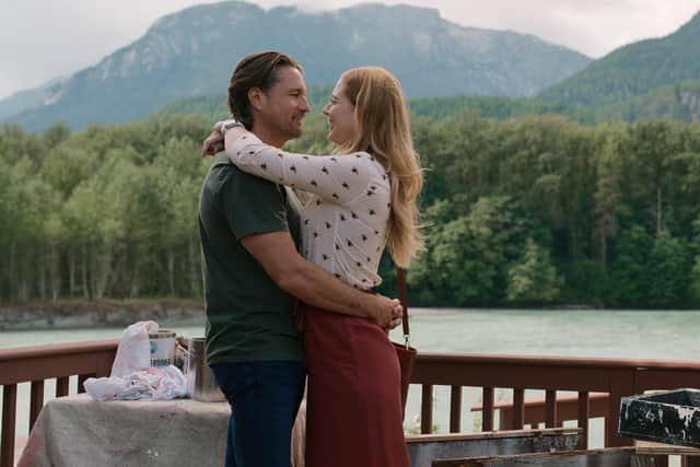 Martin Henderson as Jack Sheridan and Alexandra Breckenridge as Mel Monroe, embracing in front of a lake (Credit: Netflix)
