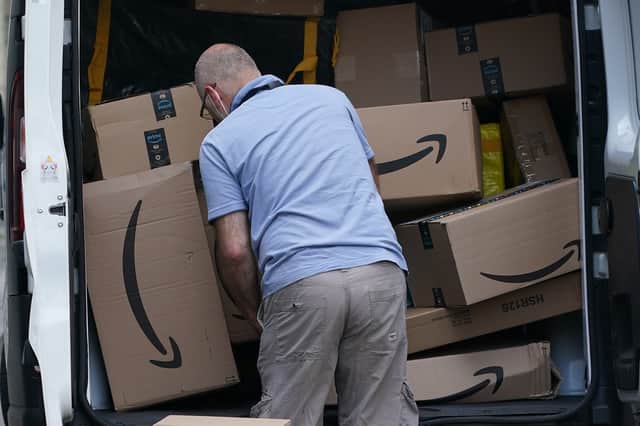 <p>Amazon parcels being delivered (Getty)</p>