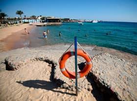 Tourists sunbathe at a beach in Egypt’s Red Sea resort town of Hurghada on August 25, 2018 (Photo by AFP via Getty Images)