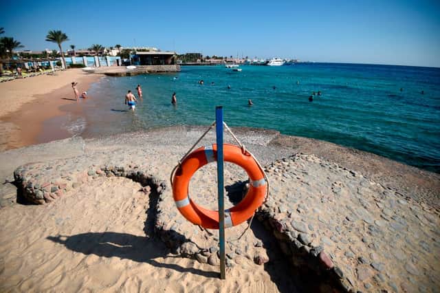<p>Tourists sunbathe at a beach in Egypt’s Red Sea resort town of Hurghada on August 25, 2018 (Photo by AFP via Getty Images)</p>