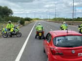 Police have been stopping slow-moving convoys on motorways across the UK today, as drivers protest rising fuel prices. (Credit: PA)