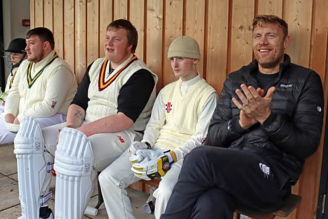 A cricket dugout. Teenagers Josh, Ben, and Ethan sit with Freddie, supporting the team at Patterdale Cricket Club (Credit: BBC/South Shore/Cath Tudor)