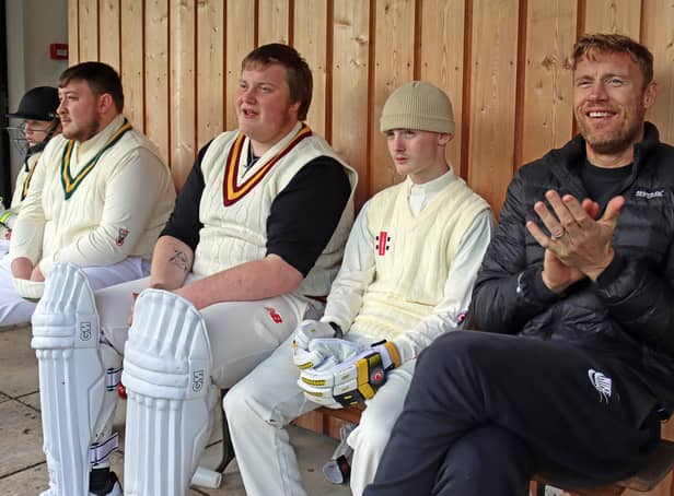 <p>A cricket dugout. Teenagers Josh, Ben, and Ethan sit with Freddie, supporting the team at Patterdale Cricket Club (Credit: BBC/South Shore/Cath Tudor)</p>