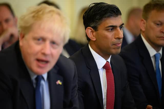 <p>Rishi Sunak listens as Boris Johnson addresses his Cabinet (Getty Images)</p>