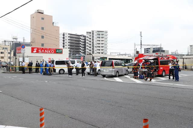 A general view shows workers at the scene after an attack on Japan’s former prime minister Shinzo Abe at Kintetsu Yamato-Saidaiji station square in Nara on July 8, 2022. (Photo by STR/JIJI PRESS/AFP via Getty Images)