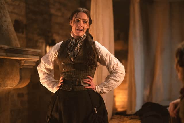 Suranne Jones as Anne Lister in Gentleman Jack, stood next to a fireplace looking flustered, hands on her hips (Credit: BBC/Lookout Point/HBO/Aimee Spinks)