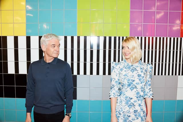 Philip Schofield and Holly Willoughby turning to look at one another, their backs pressed against a colourful tiled wall (Credit: Jon Gorrigan/ITV)