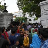 People crowd inside the premises of Sri Lanka's presidential palace, in Colombo on July 10, 2022, a day after it was overrun by anti-government protestors. - Sri Lanka's colonial-era presidential palace has embodied state authority for more than 200 years, but on July 10 it was the island's new symbol of "people power" after its occupant fled. (Photo by Arun SANKAR / AFP) (Photo by ARUN SANKAR/AFP via Getty Images)