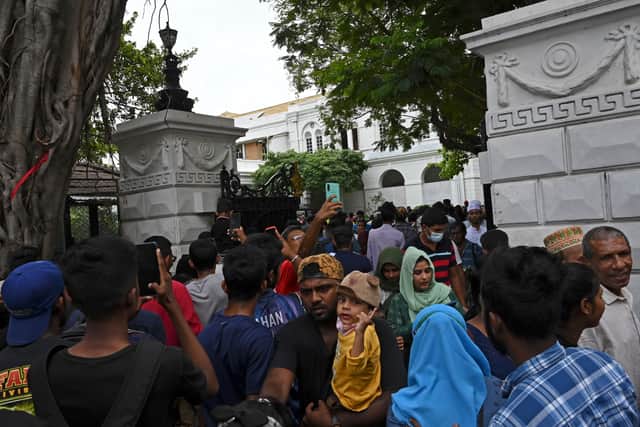 People crowd inside the premises of Sri Lanka's presidential palace, in Colombo on July 10, 2022, a day after it was overrun by anti-government protestors. - Sri Lanka's colonial-era presidential palace has embodied state authority for more than 200 years, but on July 10 it was the island's new symbol of "people power" after its occupant fled. (Photo by Arun SANKAR / AFP) (Photo by ARUN SANKAR/AFP via Getty Images)