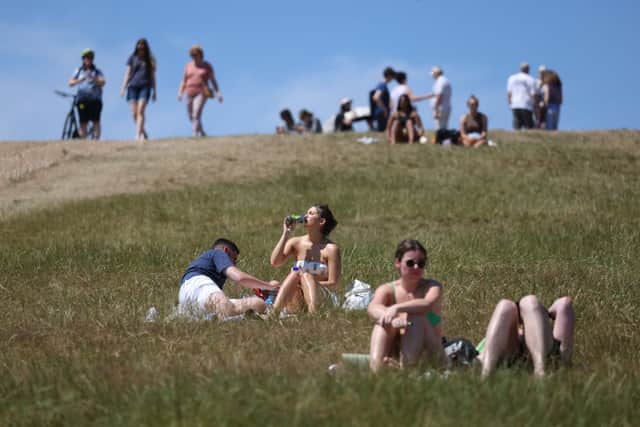 People sunbathe on Primrose Hill on July 10, 2022 in London, England. Weather forecasts have predicted a heatwave across much of the UK. (Photo by Hollie Adams/Getty Images)