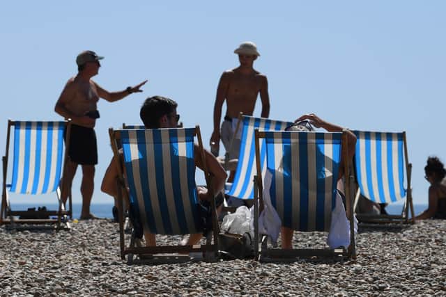People sunbath on Brighton beach as the South of England basks in a summer heatwave on August 07, 2020 in Brighton, United Kingdom. (Photo by Mike Hewitt/Getty Images)