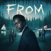 Harold Perrineau in a promotional image for From, turned away from the viewer but looking back, afraid (Credit: Sky)