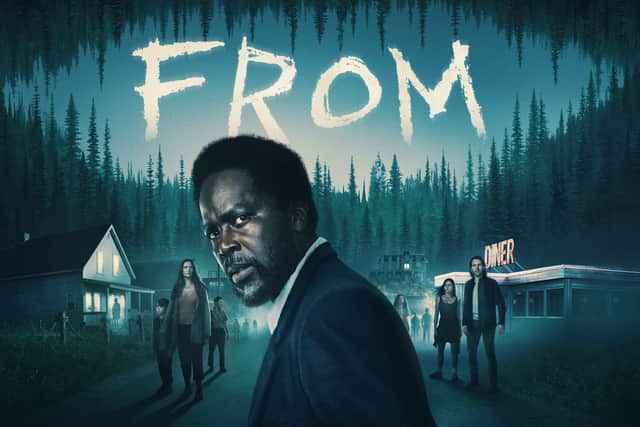 Harold Perrineau in a promotional image for From, turned away from the viewer but looking back, afraid (Credit: Sky)