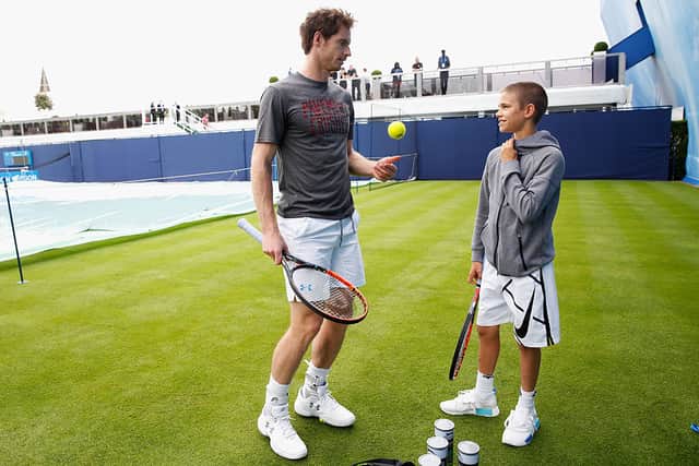 Andy Murray (L) speaks with Romeo Beckham after the pair hit a few balls prior to Murray’s practice session at the Aegon Championships at Queens Club on June 12, 2016 in London, England.  (Photo by Joel Ford/Getty Images)