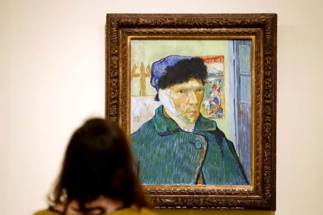 A visitor looks the painting Self Portrait with Bandaged Ear (1889) by Vincent Van Gogh (Photo by FRANCOIS GUILLOT/AFP via Getty Images)