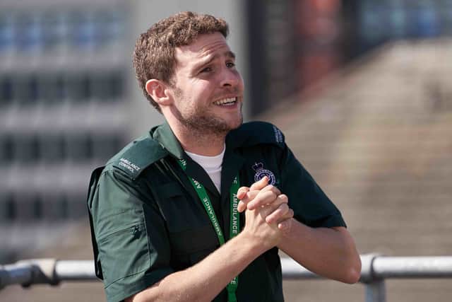 Iain De Caestecker as Gabe, wearing his paramedic uniform. His hands are clasped, as though pleading, and he looks frantic (Credit: BBC/Hartswood Films/Anne Binckebanck)
