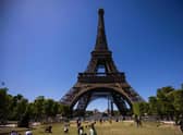 People walk on the Champ de Mars near the Eiffel Tower in Paris on July 8, 2022. (Photo by Sameer Al-DOUMY / AFP) (Photo by SAMEER AL-DOUMY/AFP via Getty Images)