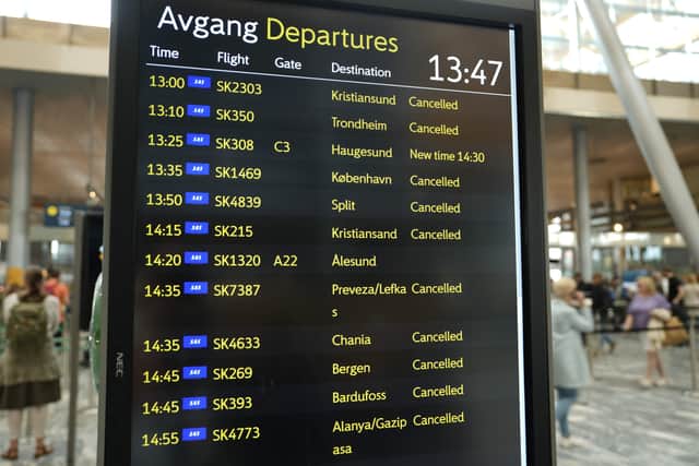 Picture taken on July 4, 2022 shows an information board announcing cancelled flights in the departure hall at Oslo Airport  (Pic: NTB/AFP via Getty Images)