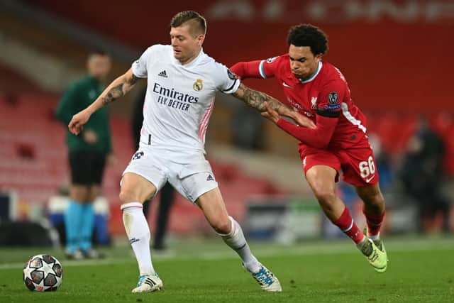Toni Kroos of Real Madrid holds off Trent Alexander-Arnold of Liverpool during the UEFA Champions League Quarter Final Second Leg match between Liverpool FC and Real Madrid at Anfield on April 14, 2021 in Liverpool, England. (Photo by Shaun Botterill/Getty Images)
