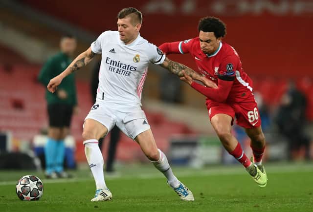 Toni Kroos of Real Madrid holds off Trent Alexander-Arnold of Liverpool during the UEFA Champions League Quarter Final Second Leg match between Liverpool FC and Real Madrid at Anfield on April 14, 2021 in Liverpool, England. (Photo by Shaun Botterill/Getty Images)
