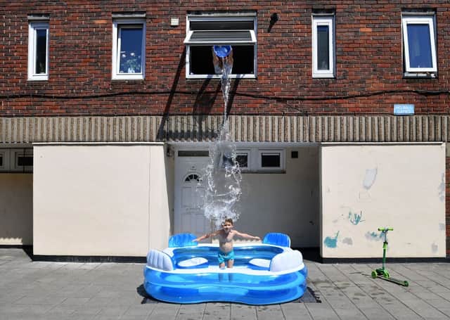 A parent helps her child stay cool in Hackney. Credit: Getty Images