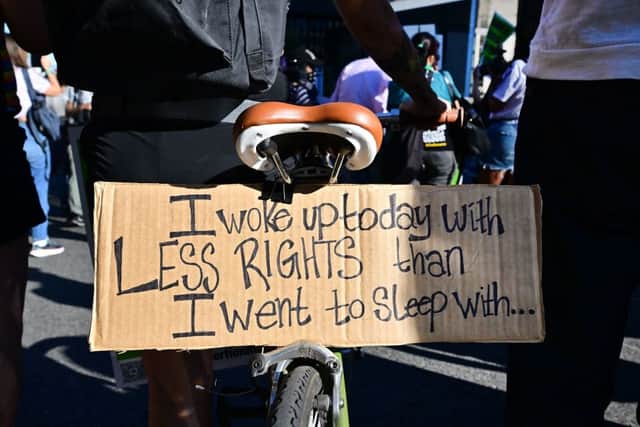 A sign attached to a bicycle reads “I Woke Up Today With Less Rights Than I Went To Sleep With” as abortion rights activists protest after the overturning of Roe Vs. Wade by the US Supreme Court, in Downtown Los Angeles, on June 24, 2022 (Photo by FREDERIC J. BROWN/AFP via Getty Images)