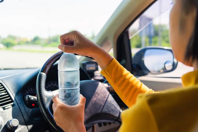 It’s not illegal to drink water while driving but you do need to remain in control and focused on driving (Photo: Shutterstock)