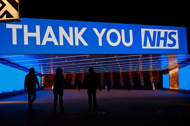 An illuminated sign thanking the NHS is pictured across Olympic Way the road to Wembley Stadium in London on March 26, 2020 (Photo by TOLGA AKMEN/AFP via Getty Images)
