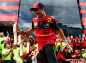 Charles Leclerc celebrates with Ferrari after winning in Austria
